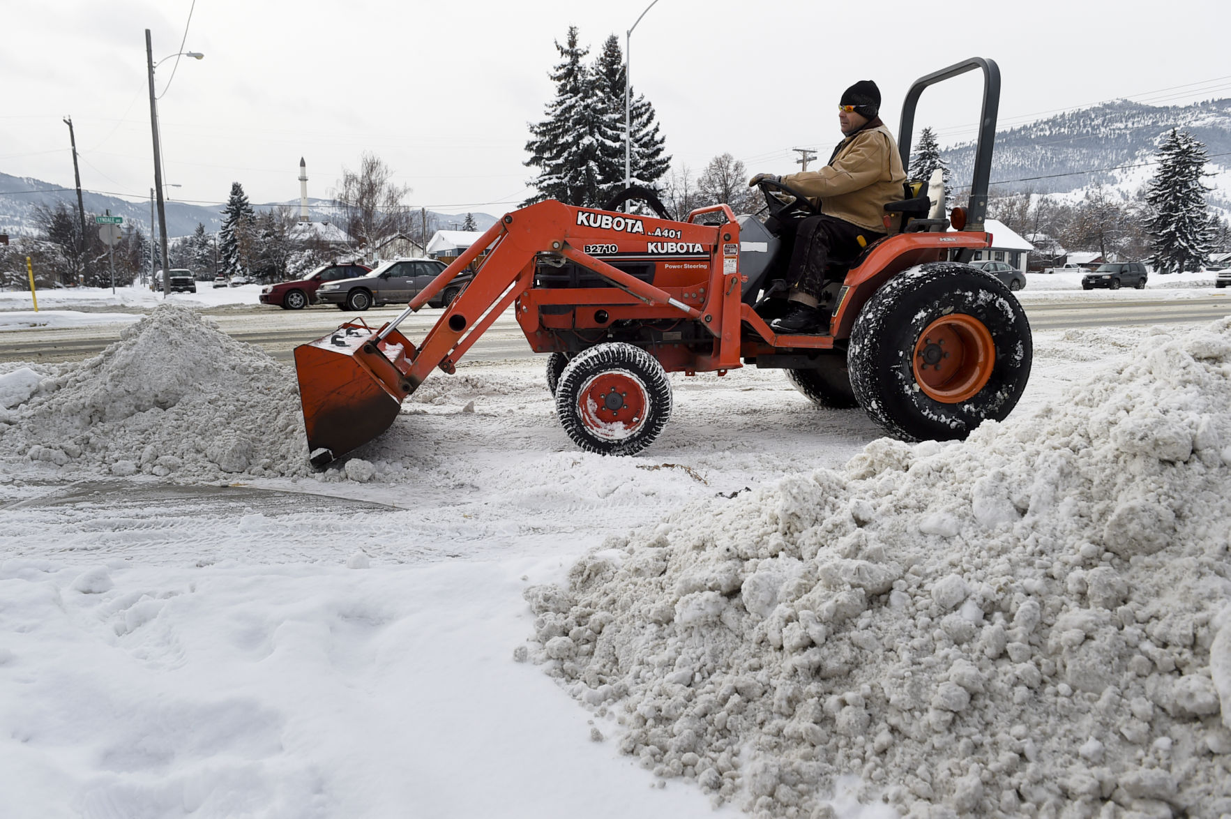 Keith Carparelli piles snow out of the way Thursday morning in preparation for the upcoming storm